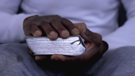 man-praying-to-god-with-hands-together-with-bible-Caribbean-man-praying-with-white-background-stock-footage