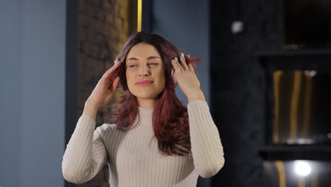 a woman immerses in music showcasing joy and emotional depth this video shows a womans deep musical journey starting with her intense emotions she smiles in joy showcasing musics universal connection