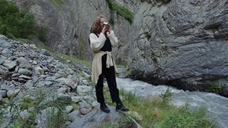 woman drinking in a mountain canyon