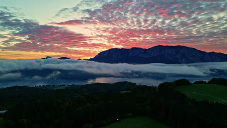 Aerial-View-of-Golden-Sky-With-Clouds-Over-Verdant-Mountain-Hills