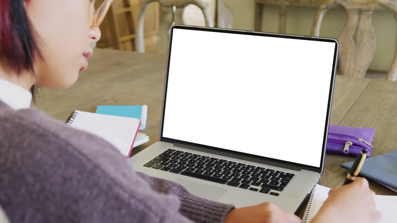Asian female student having class on laptop video call with copy space in slow motion