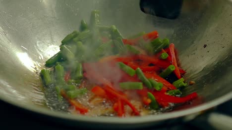 close up slow motion shot cooking fresh vegetables on hot frying pan add them to pre-toasted potatoes