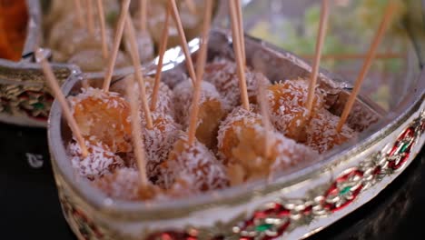 Delicious-Indian-Dessert-Gulab-Jamun-With-Coconut-On-Sticks-At-Wedding-Reception