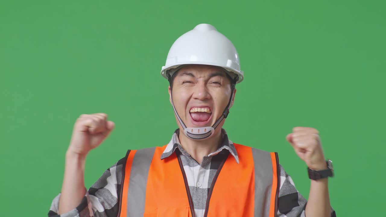 Close Up Of Asian Male Engineer With Safety Helmet Screaming Goal Celebrating Working In The Green Screen Background Studio