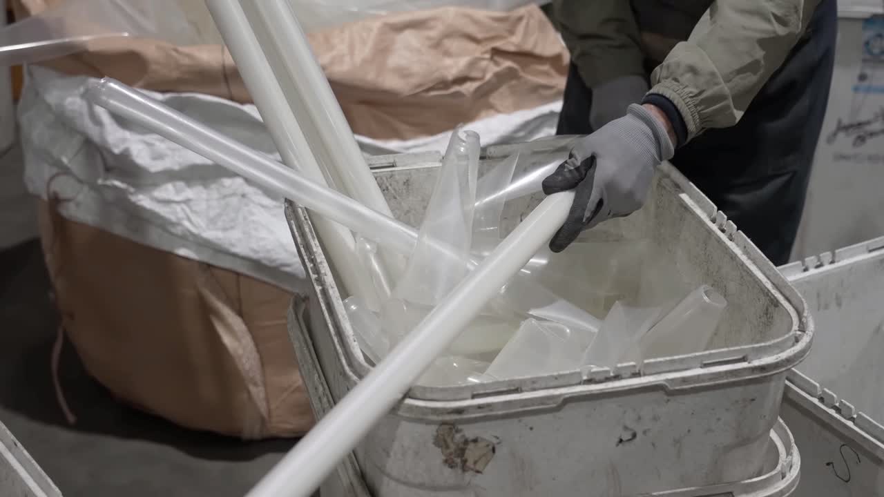 Fluorescent Tube Recycling, careful handling, hazardous waste disposal, worker in gloves, preparing lamps for recycling process. Safe disposal of lighting.