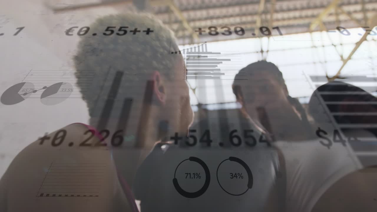Reacting to raised mitts, two women throwing punches in warehouse gym, sports tops, data overlays