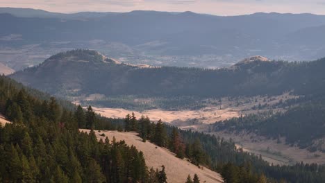 a captivating aerial perspective of harper mountain's environs near kamloops: a blend of forests and grassy mountains