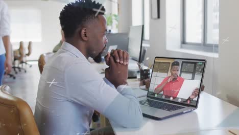 Animation-of-x-symbols-over-african-american-coworkers-discussing-in-video-call-on-laptop