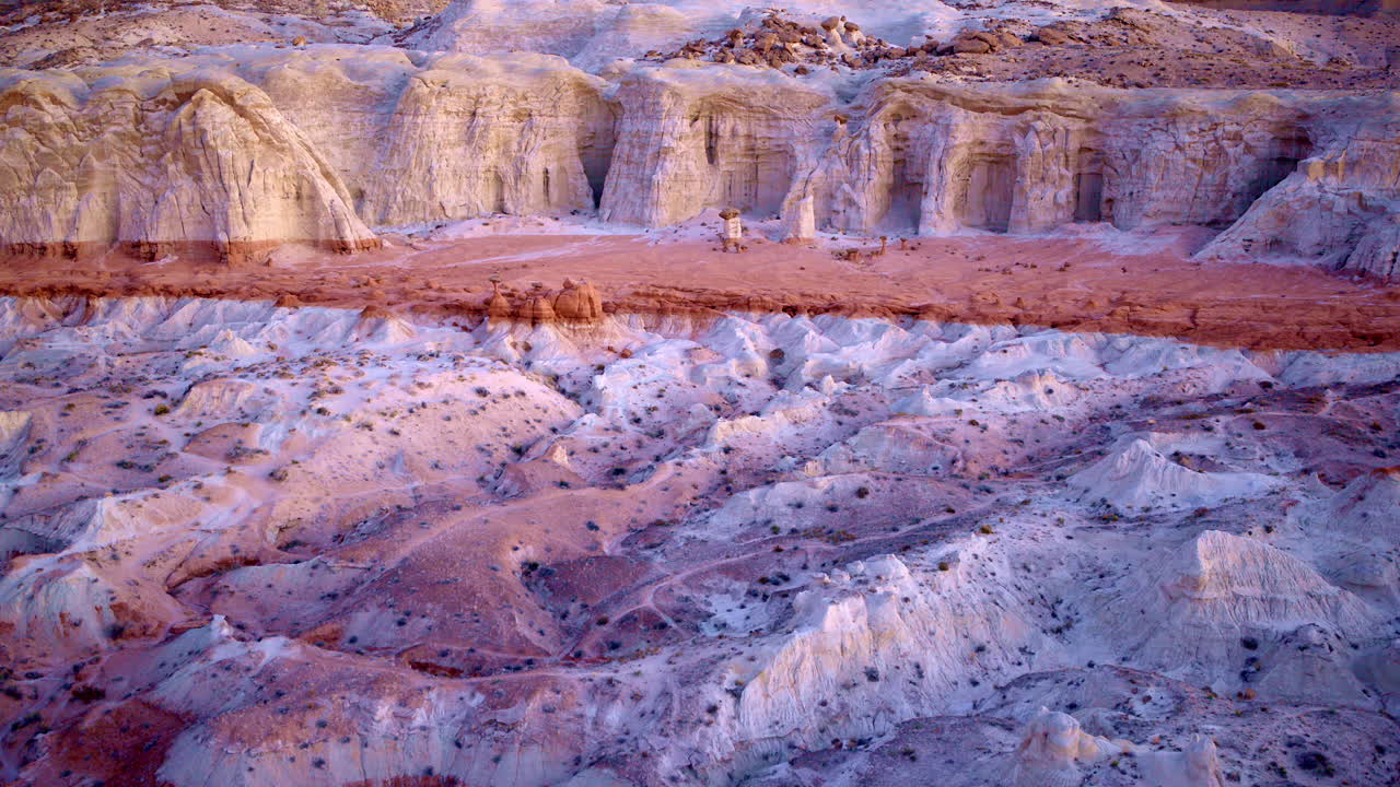 Drone glides above toadstool hoodoos, unveiling a dreamlike mix of color and stone.