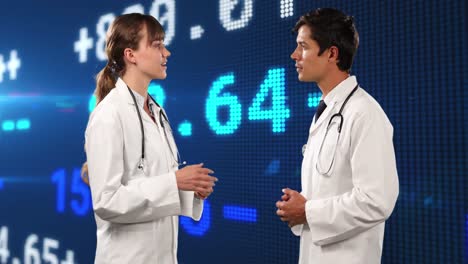 Animation-of-financial-data-and-graphs-over-caucasian-female-and-male-doctors