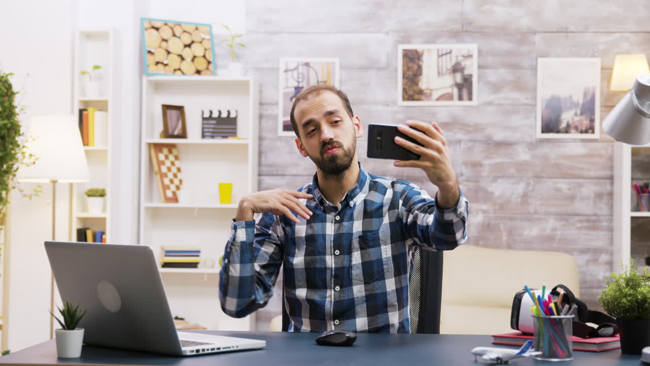 Man taking a selfie in his home office