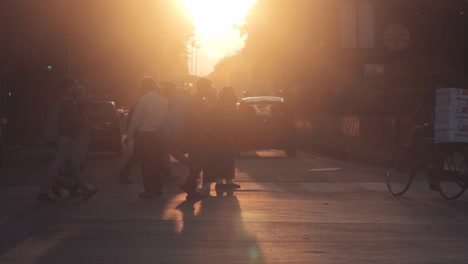 a cyclist and pedestrians going down a sunset boulevard