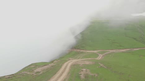 aerial flying over misty baboon valley along empty path in baboon valley in kashmir