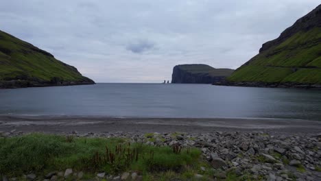 drone descends on the atlantic coast of tjornuvik with distant view of risin og kellingin