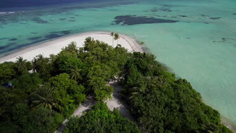 Aerial-dolly-in-revealing-tropical-and-exotic-white-sandy-empty-beach-with-turquoise-waters-in-Maldives