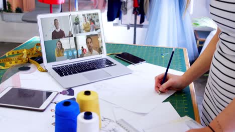 female designer having a video conference with multiple people