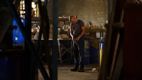 worker working with pipe in foundry workshop 4k