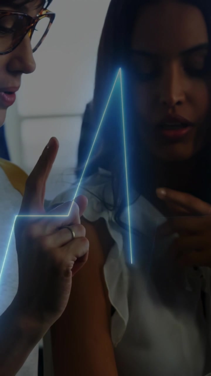 Vertical video: User tapping tablet causing ECG overlay reading health glassed peer pointing aboard