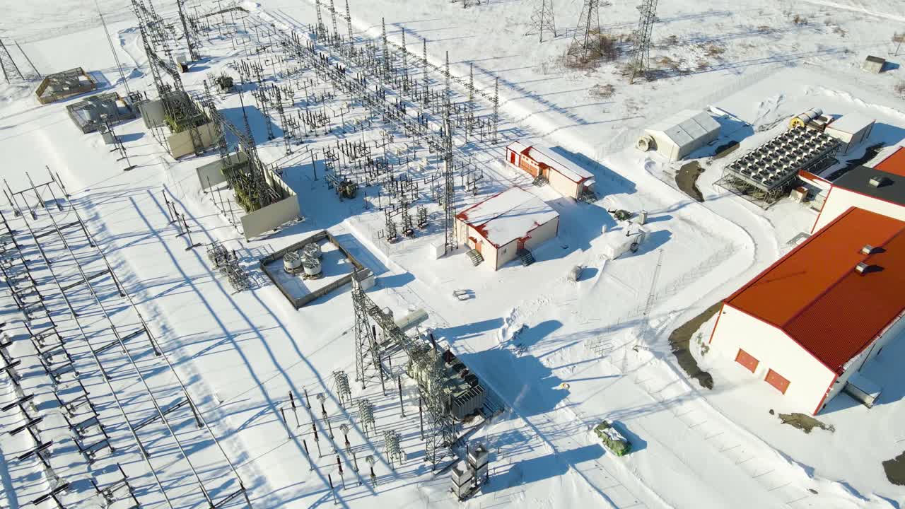 Modern high voltage substation with transformers and battery storage operating in harsh winter conditions, symbolizing energy infrastructure resilience