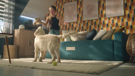 girl and puppy playing in a cozy living room