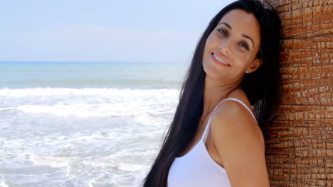 Woman-at-the-Beach-Leaning-Against-Tree-Trunk