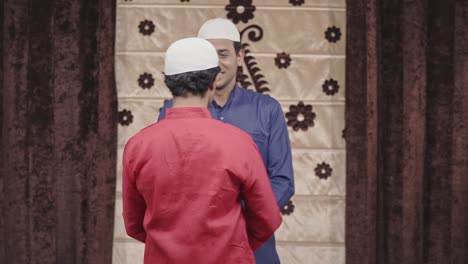 two indian muslim men hugging and celebrating eid