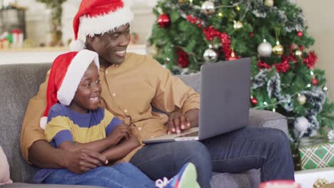 Happy-african-american-father-and-son-having-video-call