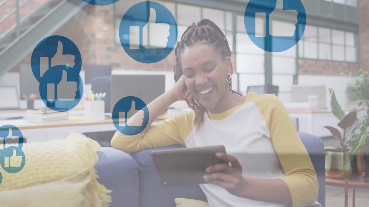 Animation of icons over african american businesswoman using tablet