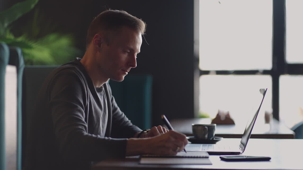 Hispanic latin man college student using laptop computer watching distance online learning seminar class remote university webinar or having virtual classroom meeting in university creative space.