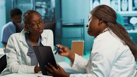 black specialist providing checkup examination on insurance with patient