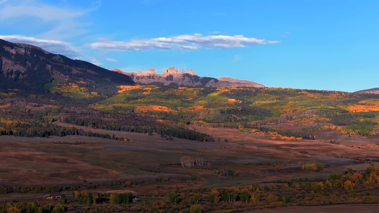 Scenic Fall autumn drive Mill Creek Ranch farm land Ohio Creek Valley Pass near Crested Butte Colorado Gunnison Country aerial drone Mill Castle rock landmark feature colorful Aspen trees forward