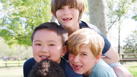 portrait of group of young boys with friends having fun in park shot in slow motion