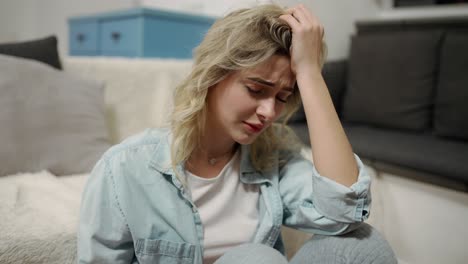 sad woman sitting alone in a empty room