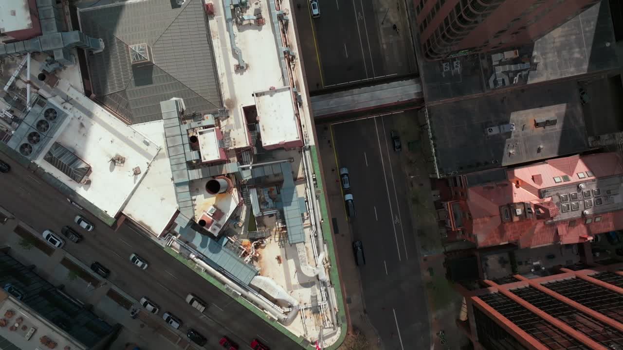 Downtown Denver crosswalk cars street traffic cityscape tall skyscraper buildings Colorado aerial drone Birdseye view afternoon shade business Republic Plaza City Park Rhino forward motion