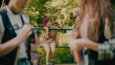 Woman-Discussing-With-Male-Friend-Near-Railing-In-Forest