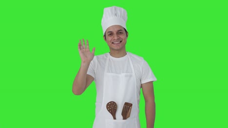 cocinero profesional indio feliz diciendo hola pantalla verde