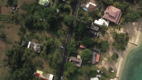 flying over mauritius island with houses and farmlands