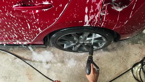 washing a red car at a car wash