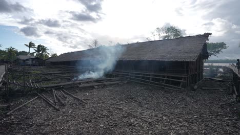 Outside-rural-village-in-Indonesia,-wooden-house-hut-near-river-in-Papua