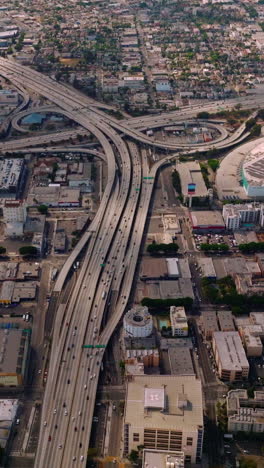 Huge road crossings at the multi-lane freeways of Los Angeles, California, USA. Amazing urban panorama with crazy traffic. Aerial view. Vertical video