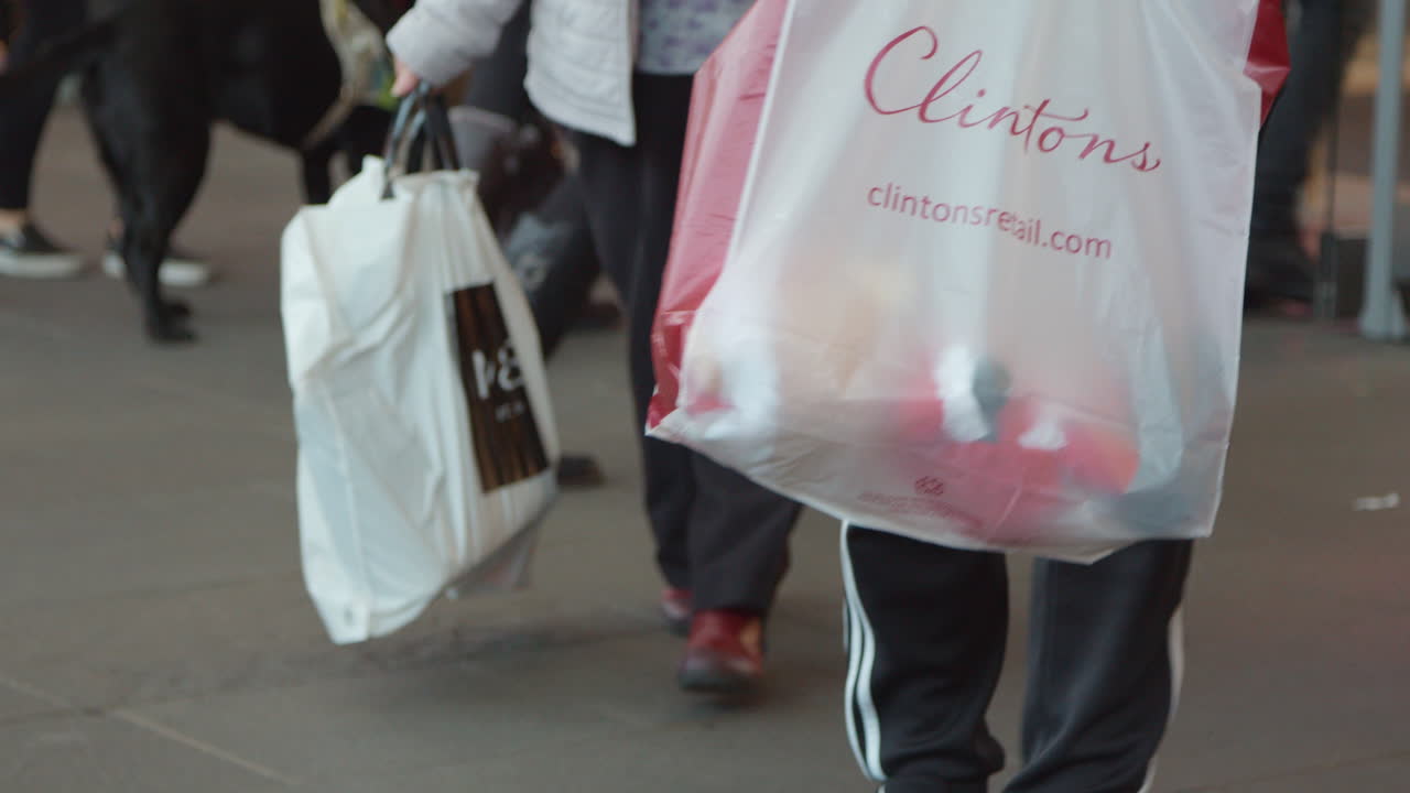 People carrying shopping bags as they leave thr shopping centre - mall