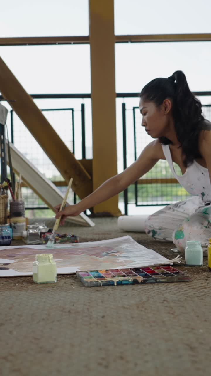 A woman painting on a canvas