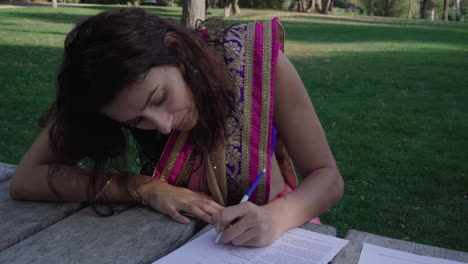 Smart-girl-in-saree-writing-text