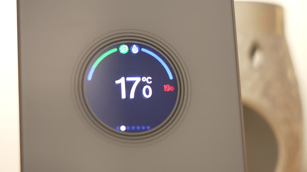 Slow Pan to Home Smart Digital Device Thermostat Controlling Temperature of House. Modern Electrical Equipment Using Internet to Warm Household. Cost of Energy in UK