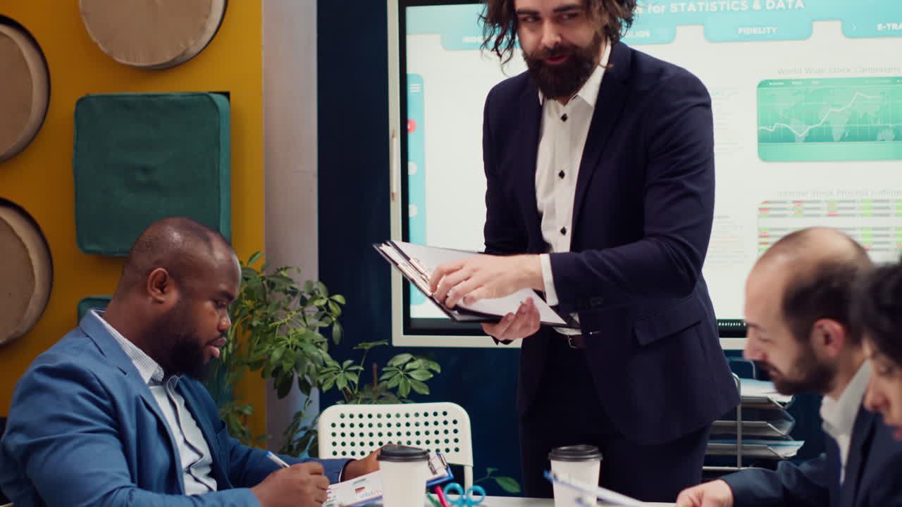 Team leader sharing clipboards with the latest performance metrics