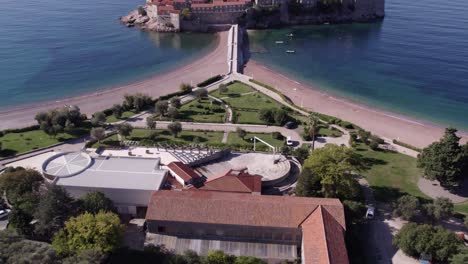 reveal shot of sveti stefan resort island in montenegro during daytime, aerial