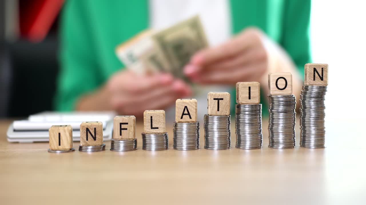 Inflation concept with coins and wooden blocks
