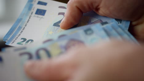 Employee-hands-counting-earnings-cash-close-up.-Worker-calculating-banknotes.