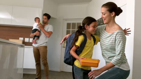 child ready to school in the kitchen with family