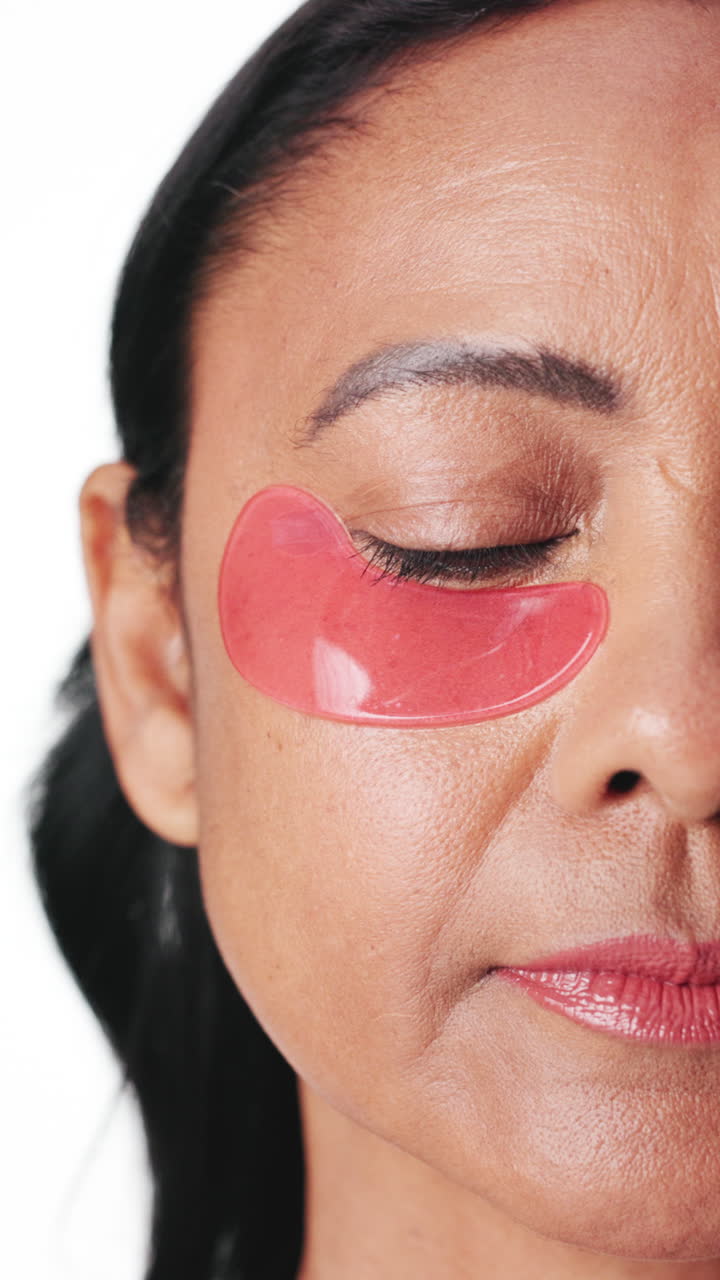 Close Up of Woman's Face with Pink Under Eye Patch